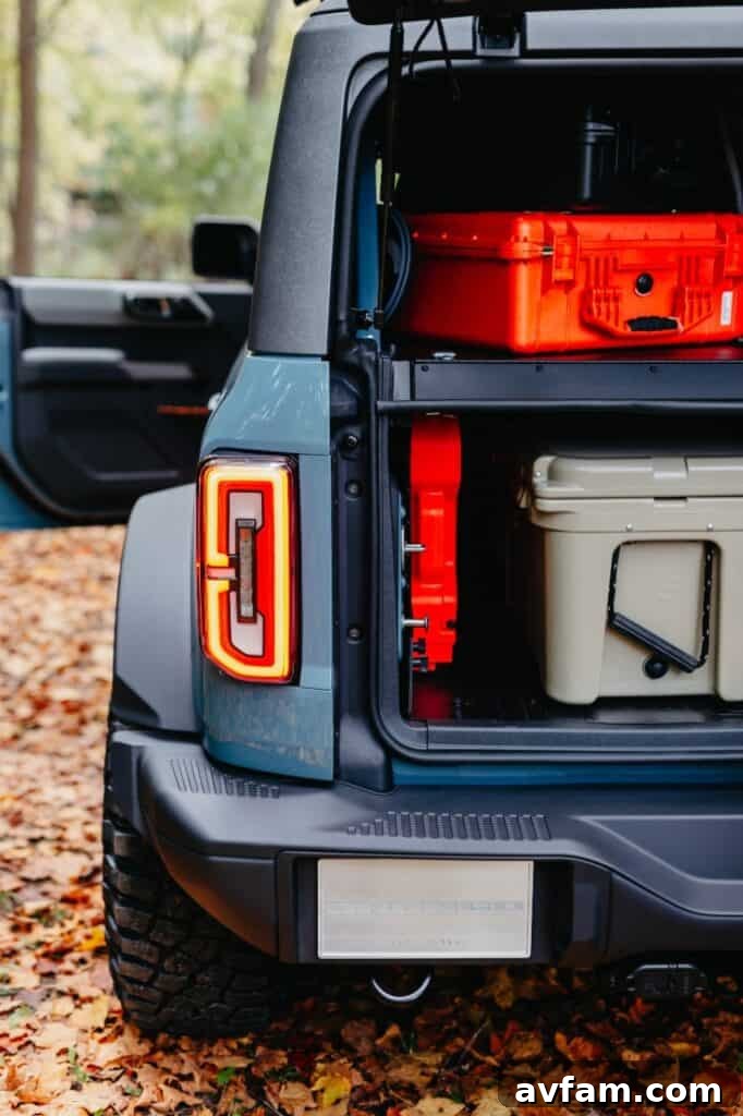 Action shot of the Bronco Overland concept driving through a wooded trail.