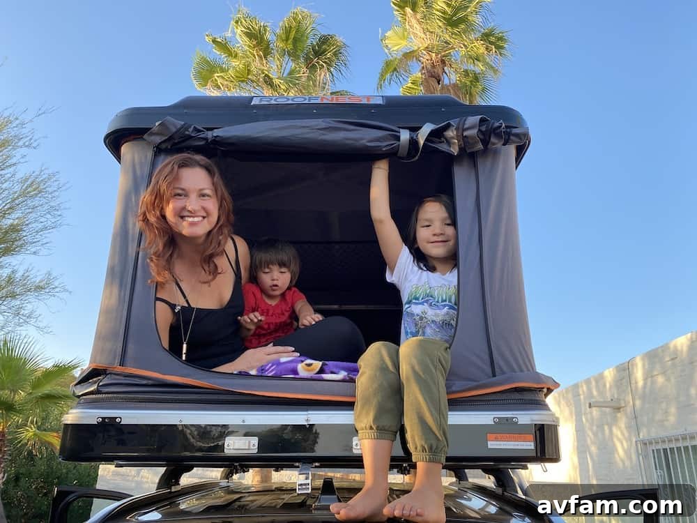 Person opening Roofnest Sparrow rooftop tent with gas struts