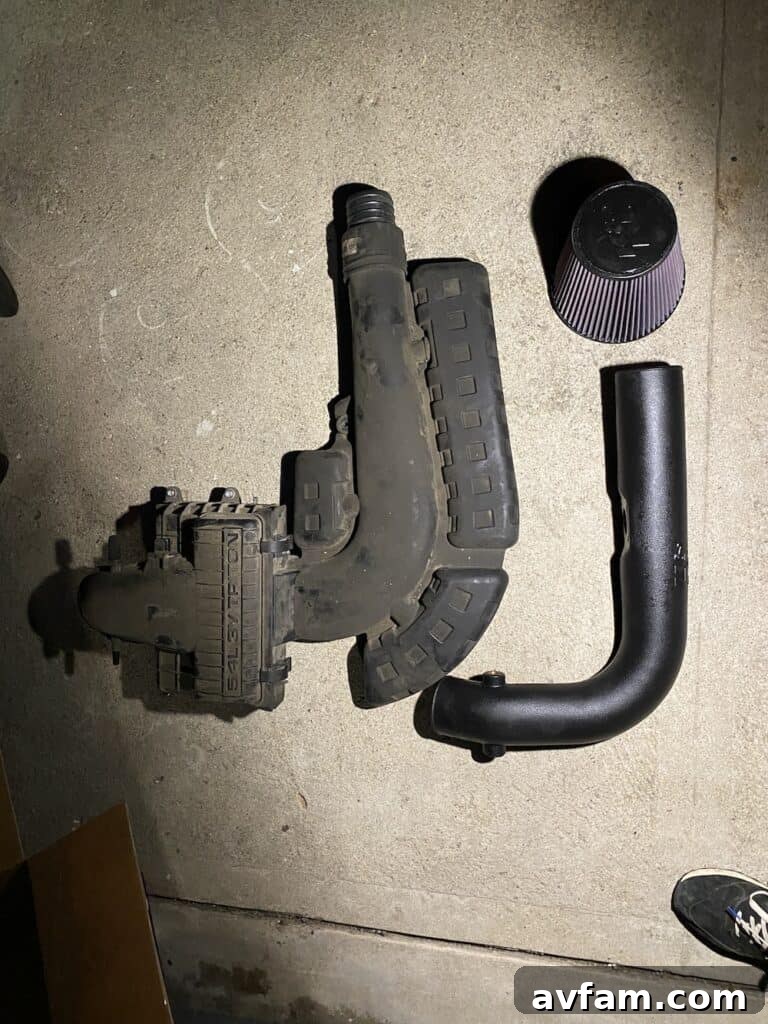 Factory vs. K&N Complete Intake System Direct comparison shot of the entire factory intake system next to the K&N cold air intake components.