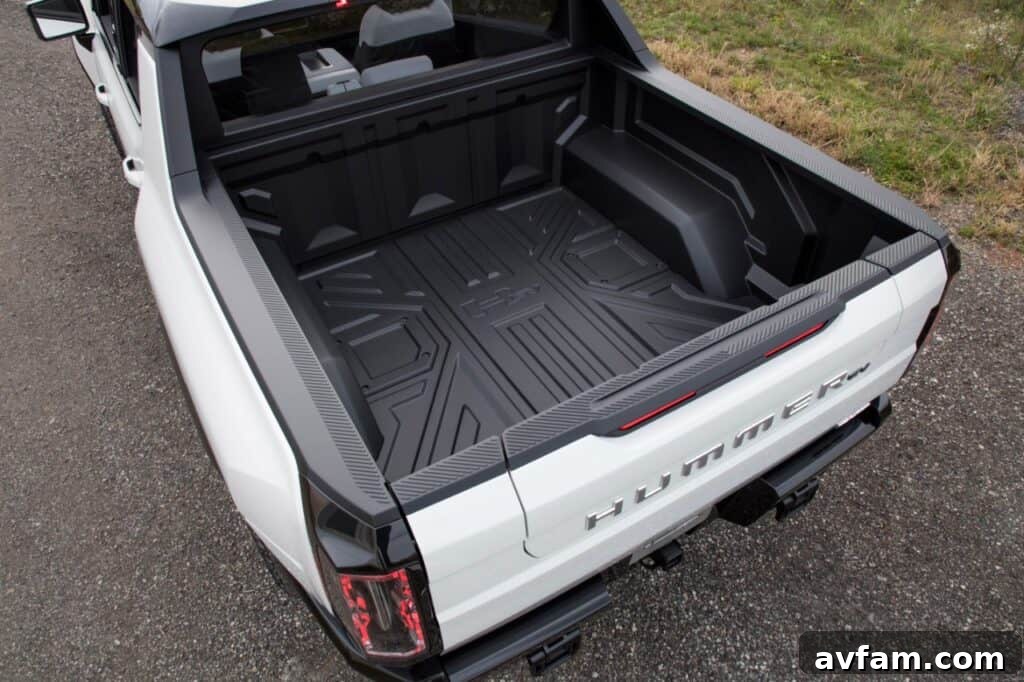 View of the GMC Hummer EV's driver's side and open door.