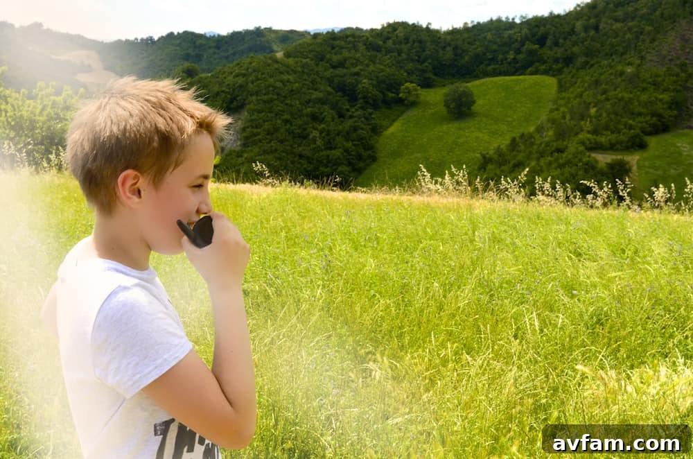 Overlander holding a GMRS radio while scouting in a green valley