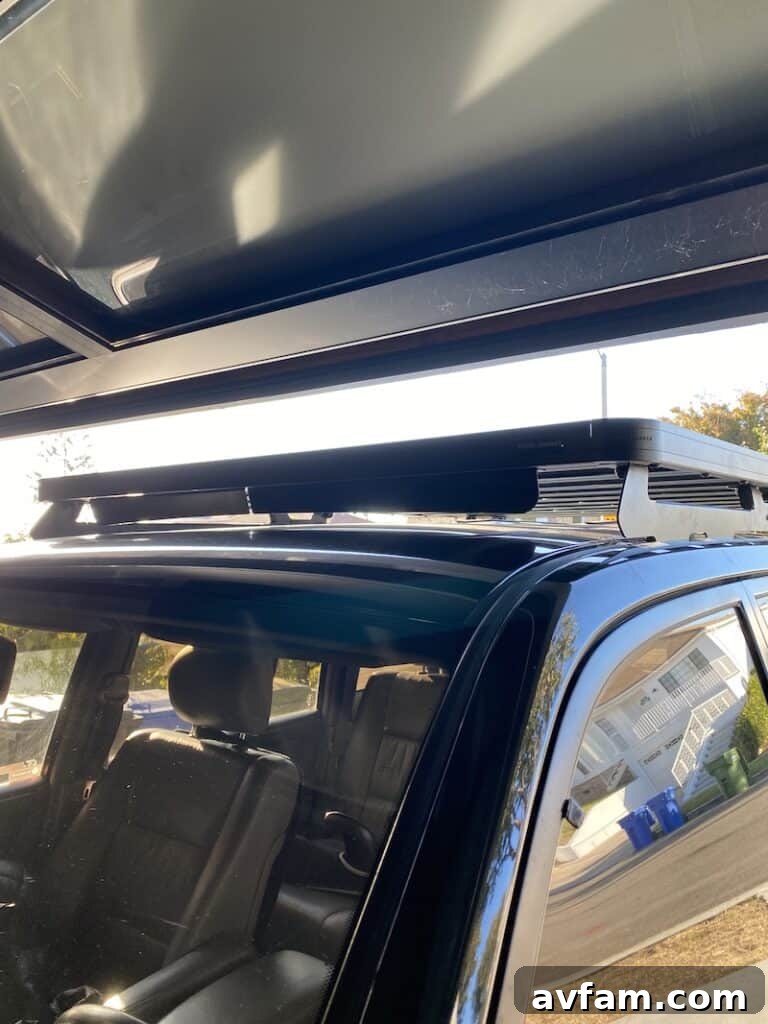Front Runner Slimline II Roof Rack installed on a 100-series Toyota Land Cruiser, showing garage clearance