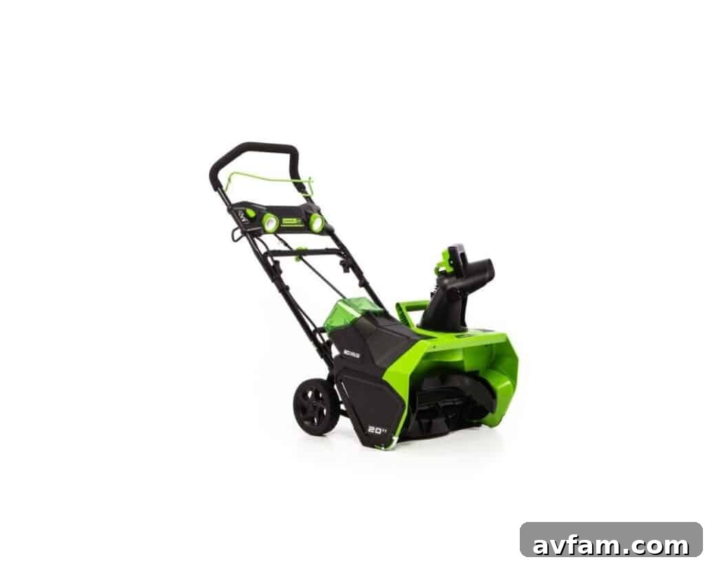 Greenworks 60V snow blower clearing a driveway