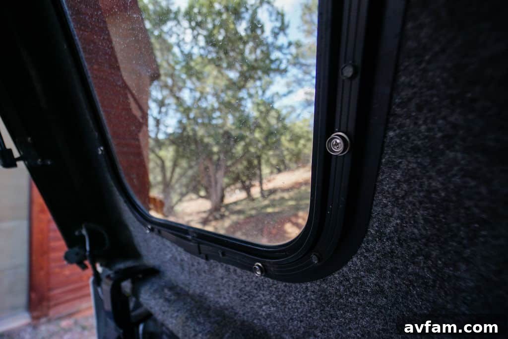 Close-up of a truck cap window with the custom privacy cover installed, from the outside.
