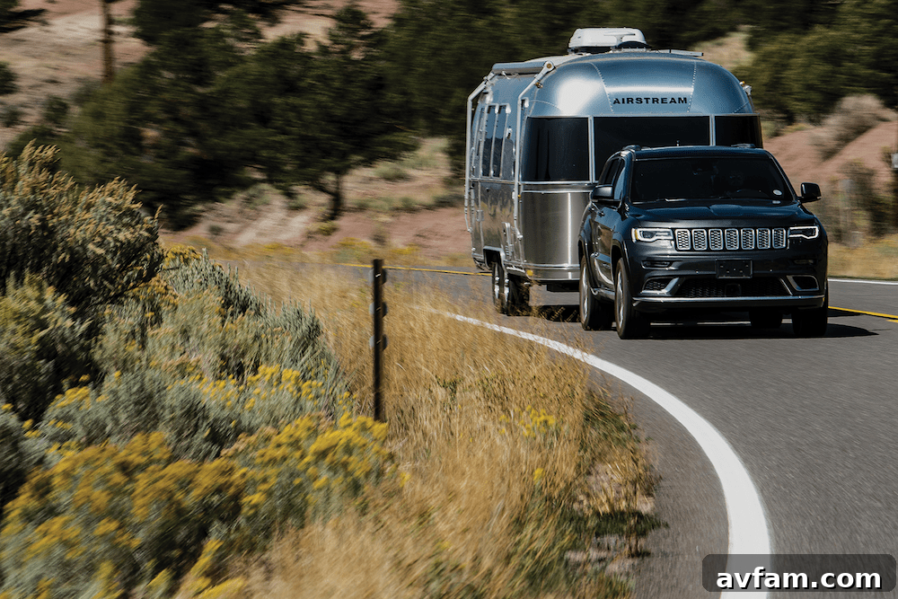 Airstream Flying Cloud 30FB Office travel trailer parked in a scenic mountain landscape, showcasing its sleek exterior and inviting remote work possibilities.