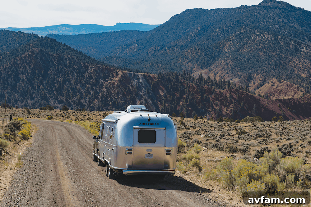 A person working comfortably at the desk inside the Airstream Flying Cloud 30FB Office, demonstrating the practical and inviting nature of the mobile workspace.