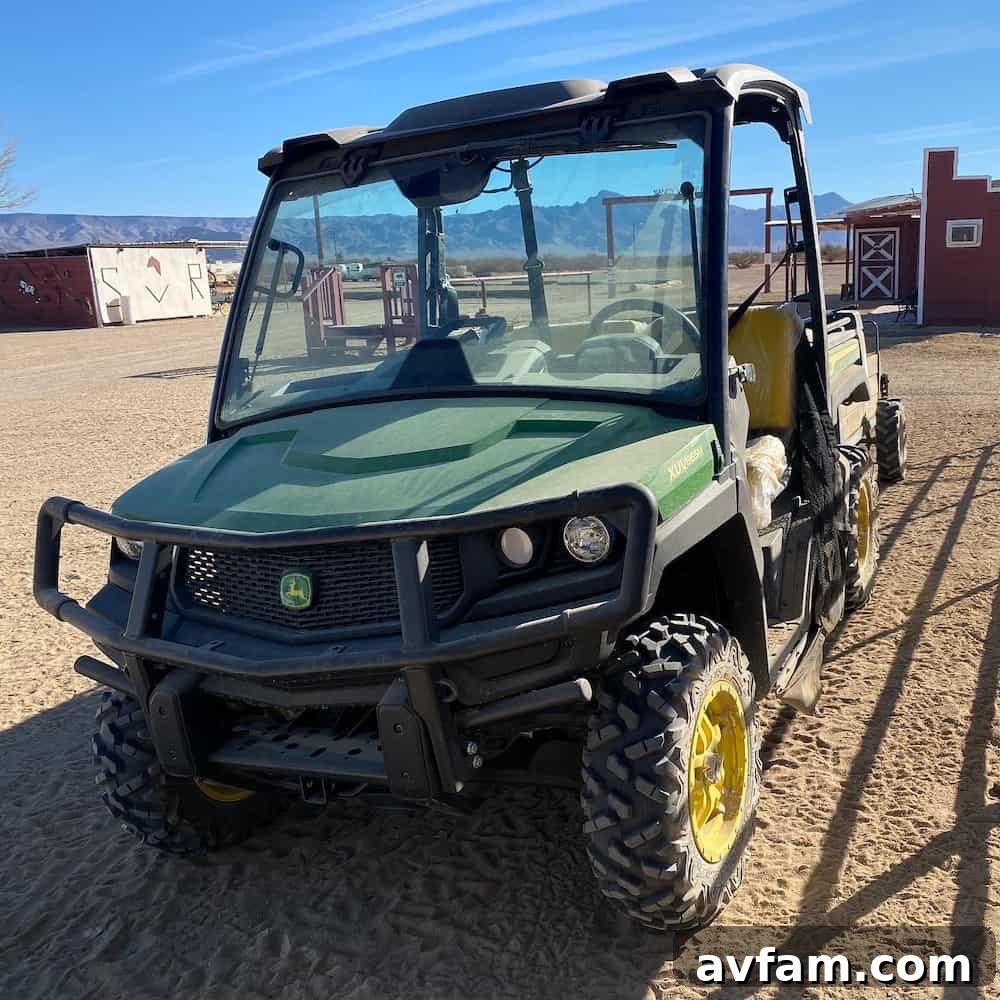 Front three-quarter view of a John Deere Gator XUV865M, showcasing its robust tires