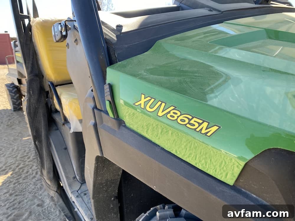 John Deere Gator XUV865M from a low angle, highlighting its ground clearance