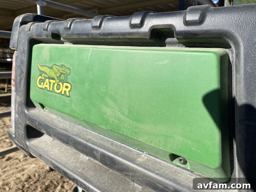 John Deere Gator XUV865M in a field with a trailer attached