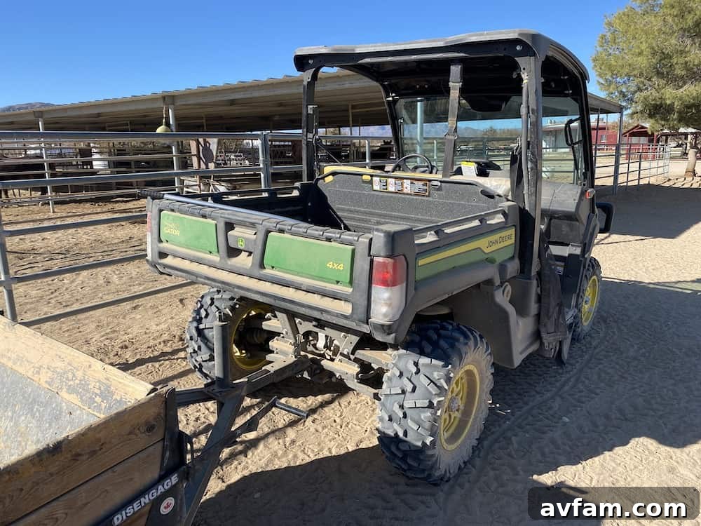 John Deere Gator XUV865M hooked up to a feed trailer, ready for work