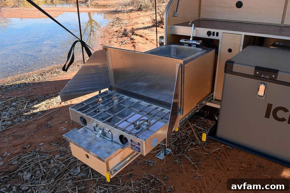 The pull-out kitchen of the Vorsheer XOC, featuring a sink, stove, and counter space