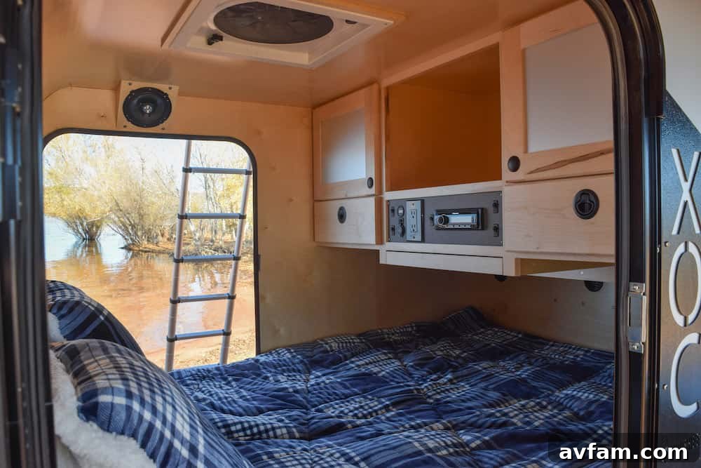 Cozy interior of the Vorsheer XOC, showing sleeping area and hardwood finishes