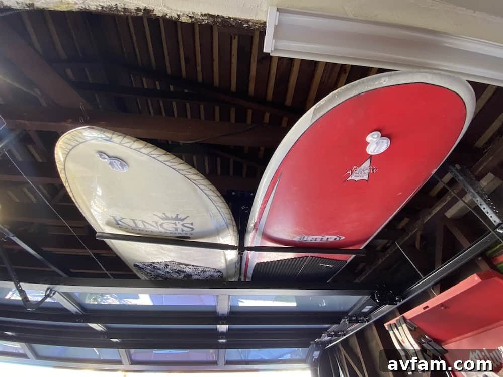 Close-up of the hanging rack supporting a variety of boards, highlighting the padded arms