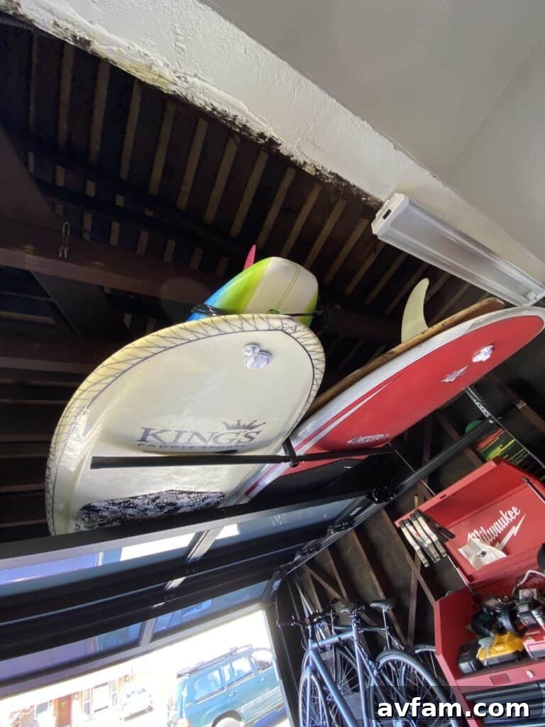 Another view of the hanging surfboard rack, showcasing its capacity and sturdy installation