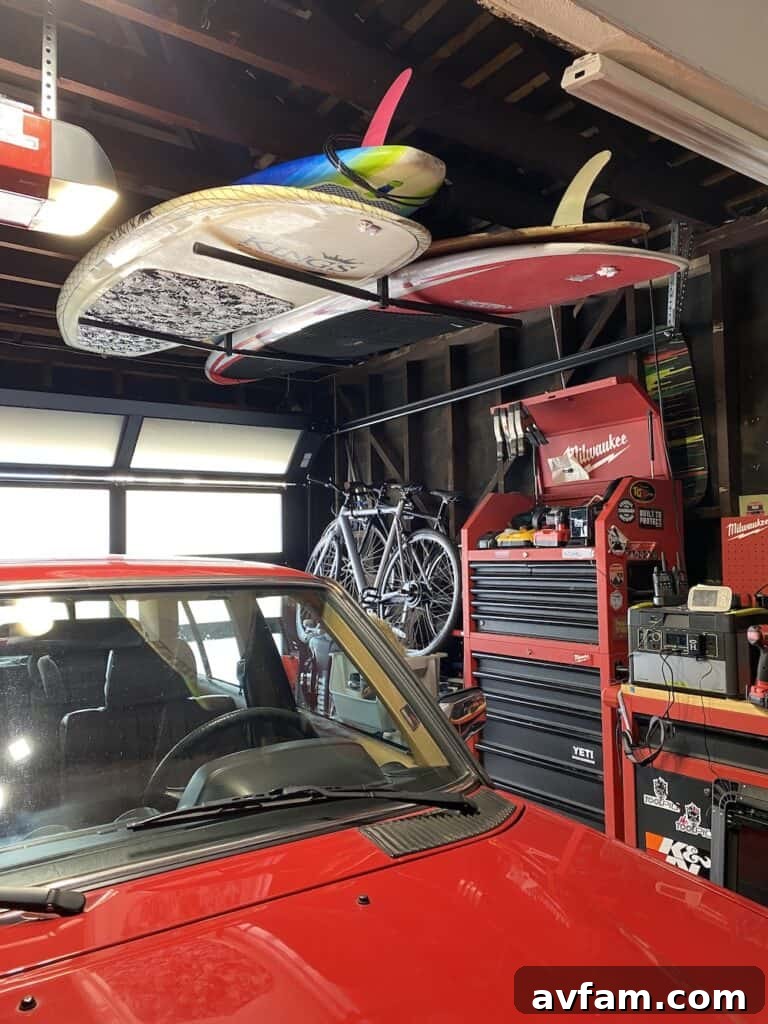 Standup paddleboards and longboards leaning vertically, still exposed to outdoor elements