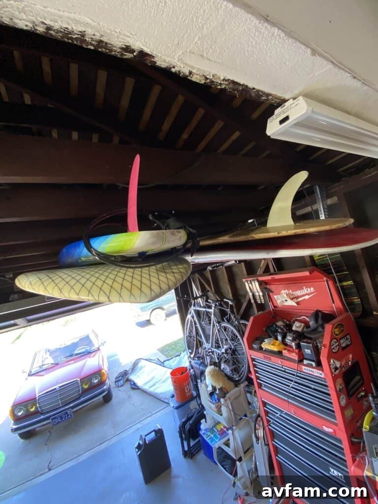 Overhead view of a garage ceiling with exposed beams, ideal for a hanging surfboard rack