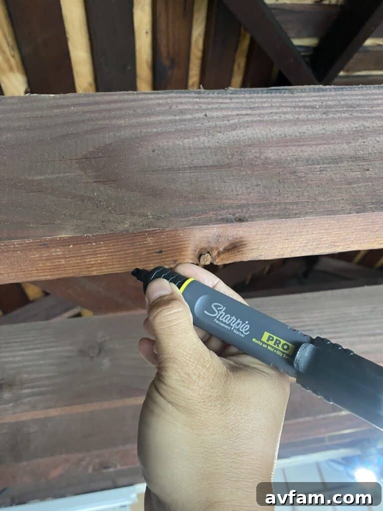 Measuring and marking exposed garage beams for precise surfboard rack placement