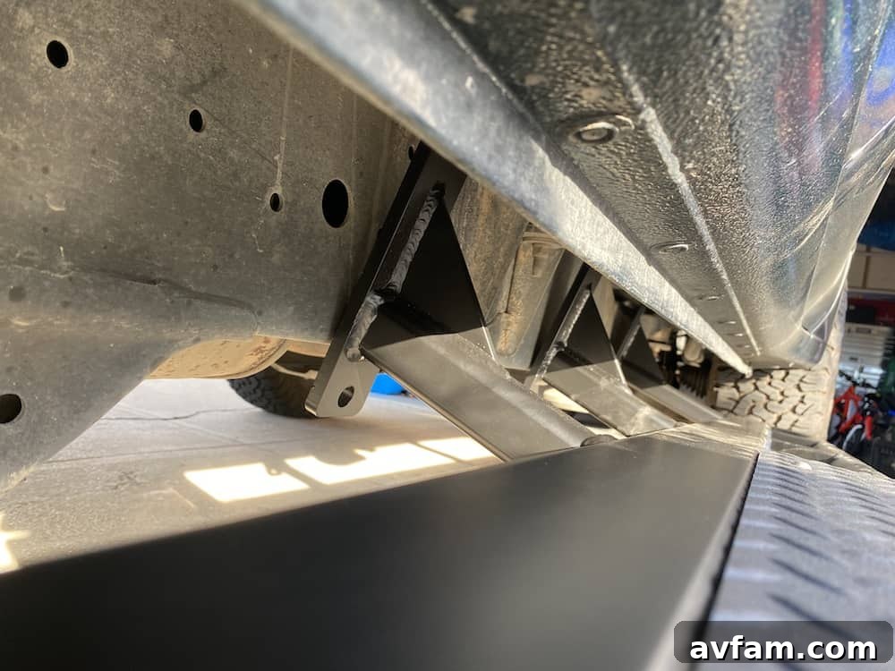 Slider Alignment Rock slider positioned under the vehicle, ready for U-bolts