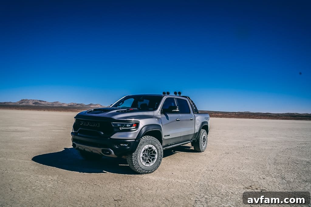TRX Ready for Adventure Ram TRX parked on a dirt road, showcasing its robust tires and suspension.