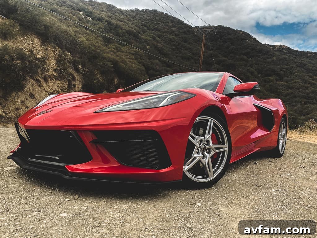 Action shot of the red C8 Convertible accelerating away, capturing its rear design and powerful stance.
