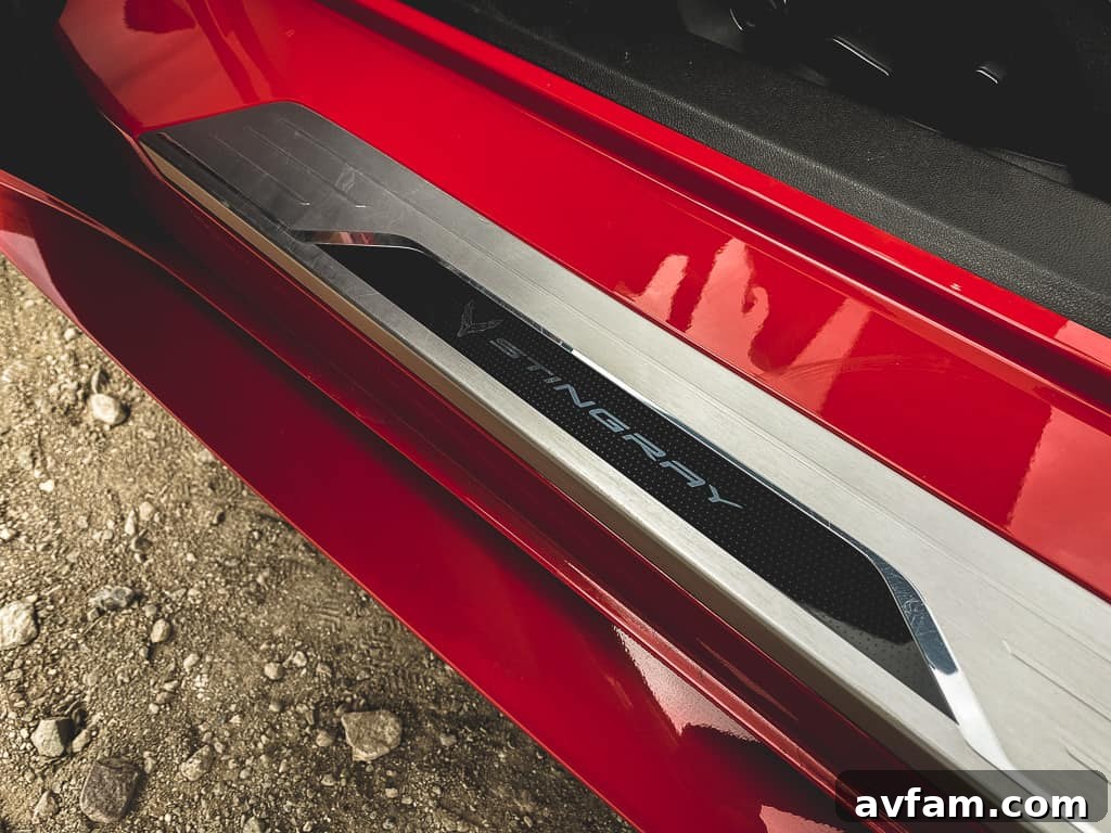 Close-up of the front wheel and fender of the red C8 Convertible, showing brake calipers and aggressive styling details.