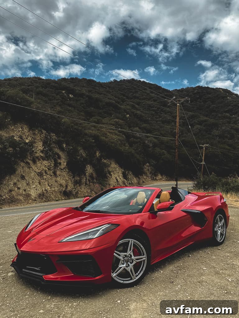 Driver's perspective inside the C8 Convertible, showcasing the digital instrument cluster and sport steering wheel.