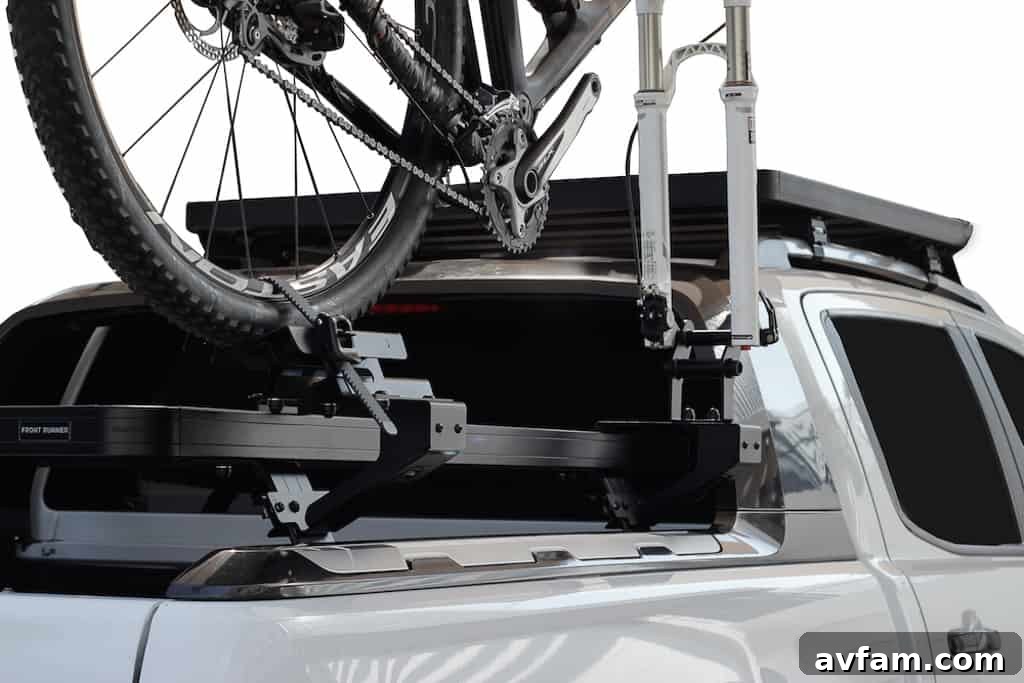 Close-up of a mountain bike securely attached to the Front Runner Side Mount Bike Carrier