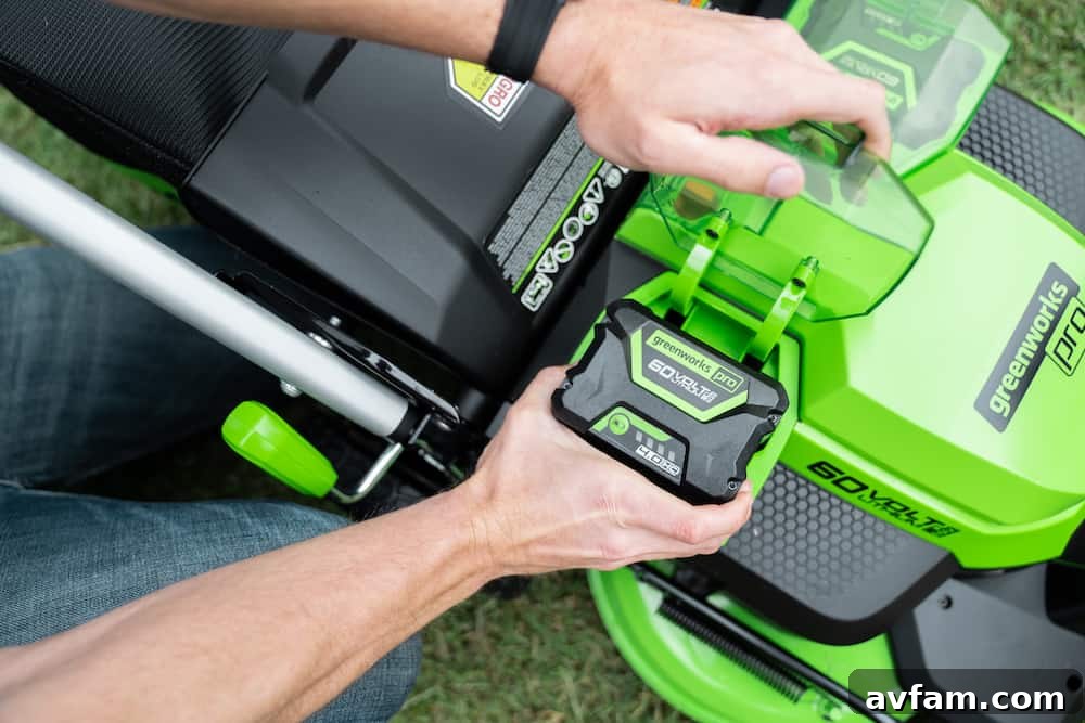 Greenworks 60V Battery and Charger A Greenworks 60V battery pack and charging station, emphasizing quick and convenient power replenishment.