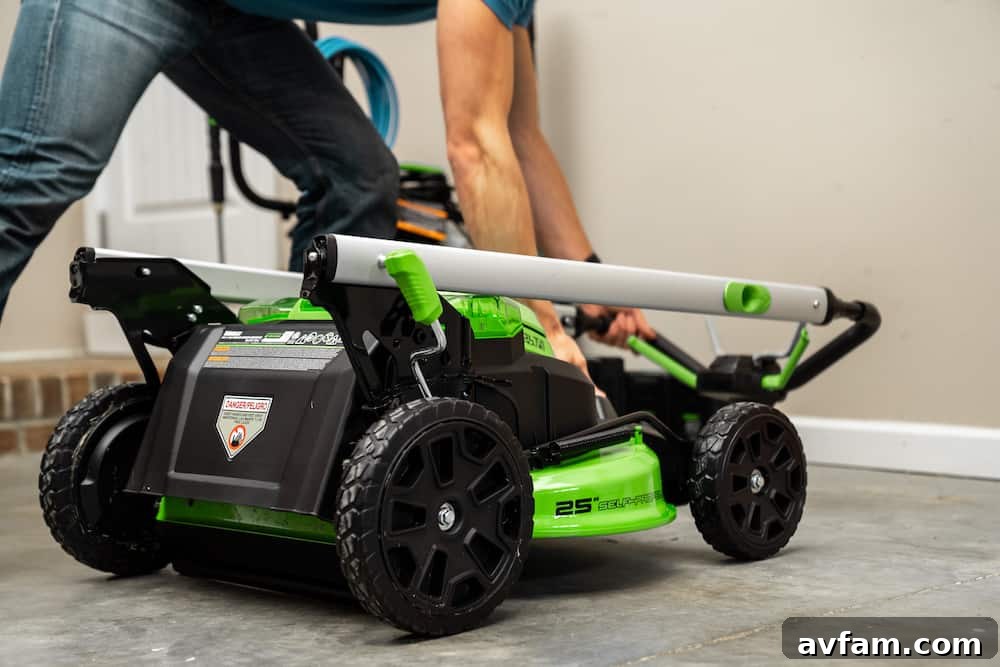 Greenworks Cordless String Trimmer Clearing Weeds A Greenworks 60V cordless string trimmer effectively clearing tall grass and weeds along a fence line, demonstrating power and maneuverability.