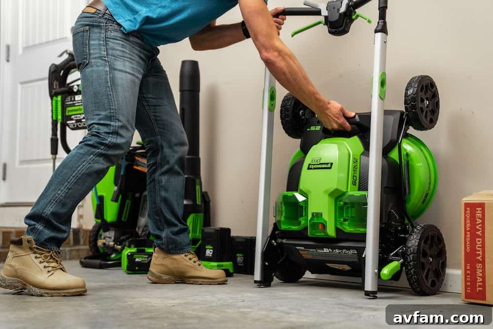 Greenworks Cordless Leaf Blower in Action A person efficiently clearing a large paved area of leaves using a Greenworks 60V cordless leaf blower, showcasing its powerful airflow.