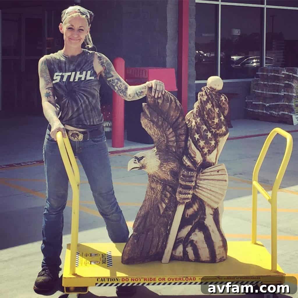 Griffon Ramsey in action, carving a large wood sculpture with a chainsaw. She demonstrates the unique blend of power and precision required for chainsaw art, transforming raw logs into intricate forms.