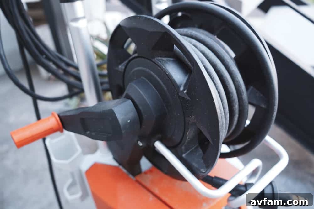 Detailed shot of the STIHL RE 110 Plus control panel and hose connection, emphasizing user-friendly design.