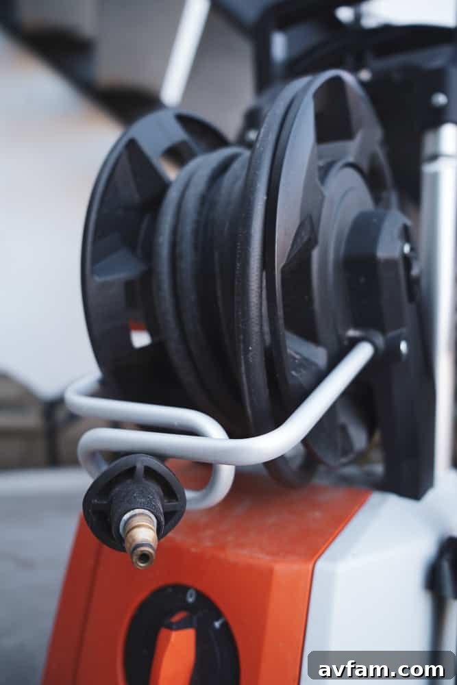 The STIHL RE 110 Plus showing its integrated hose reel, emphasizing ease of use and tidy storage.
