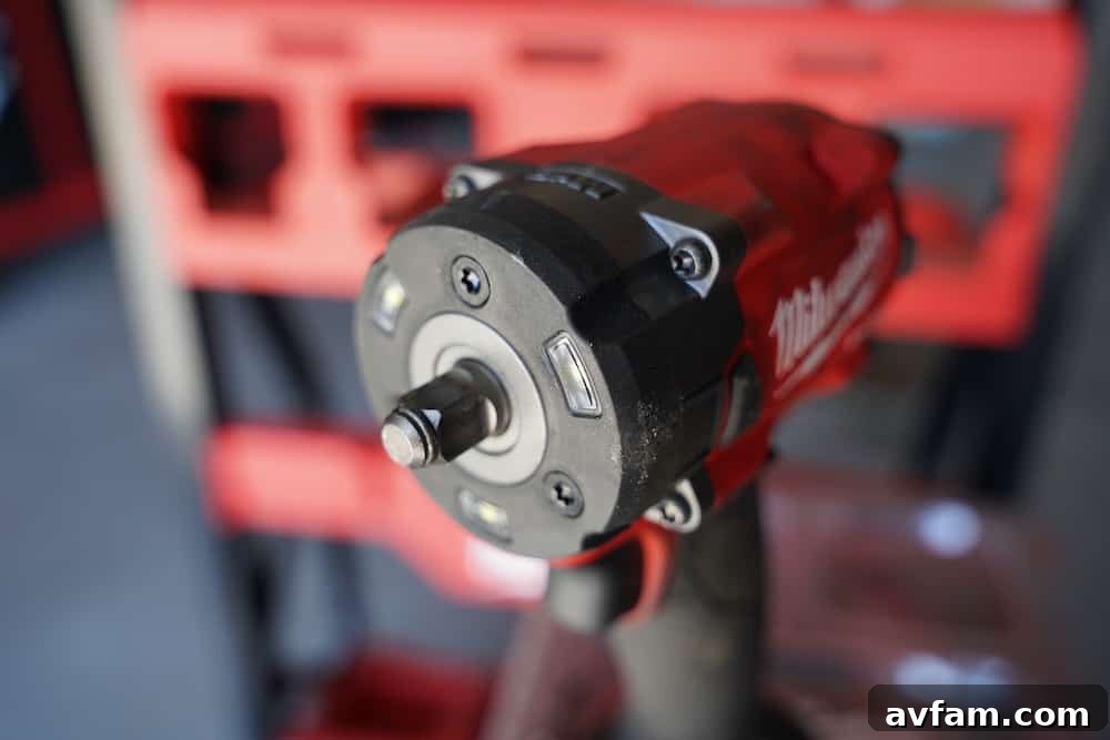 Milwaukee M18 Fuel 3/8 inch compact impact wrench in use on a vehicle