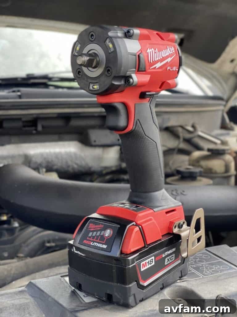 Milwaukee M18 Fuel 3/8 inch impact wrench being used on engine bay