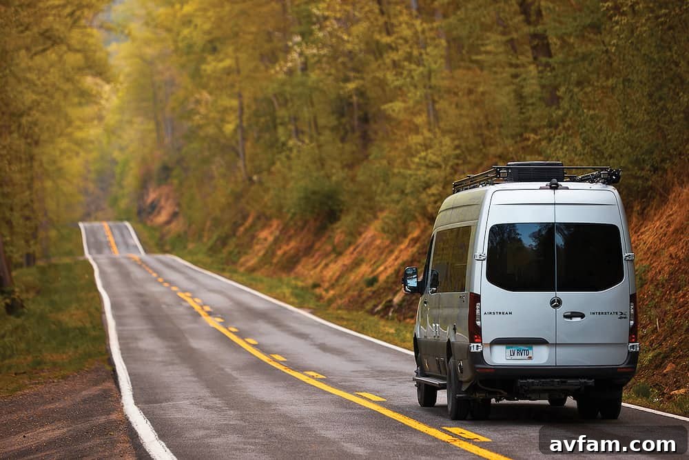 Airstream Interstate 24X on a dirt road with mountains in the background.