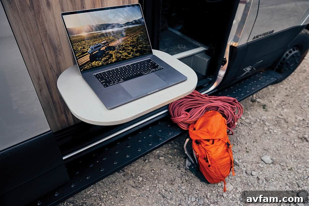 Airstream Interstate 24X interior with modular table setup and swivel chairs.