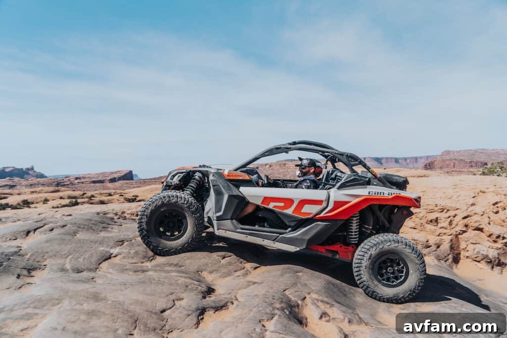 Custom Maverick X3 in Moab Scenery The custom Can-Am Maverick X3 parked against the dramatic Moab red rock cliffs.