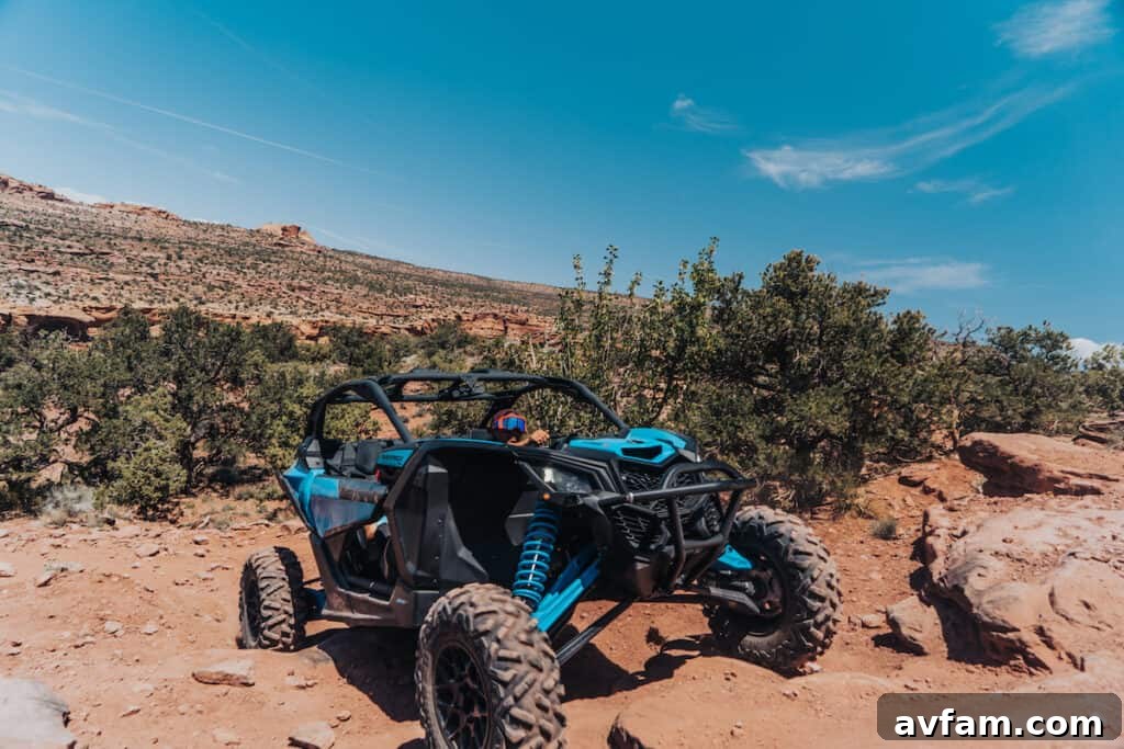 Maverick X3 Tight Trail Maneuver Can-Am Maverick X3 passing through a tight rock gate, showcasing its maneuverability.