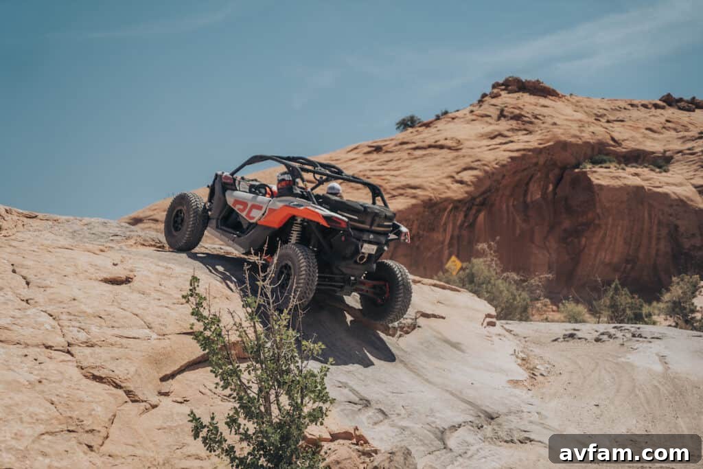 Maverick X3 Sandy Trail Can-Am Maverick X3 driving up a sandy, undulating trail in Moab.