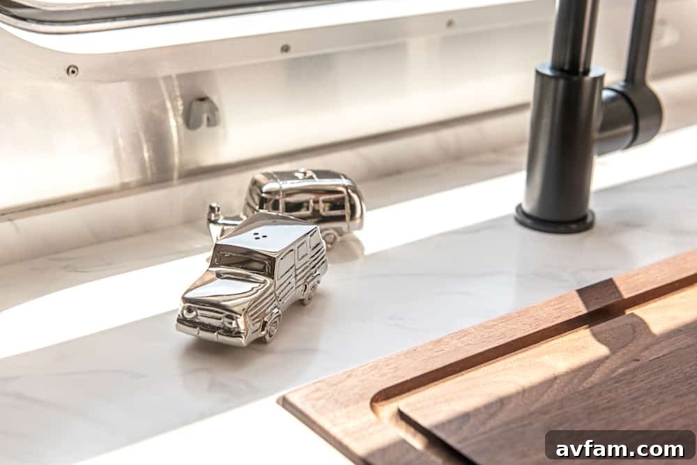 A broad exterior view of the Airstream Pottery Barn Special Edition Travel Trailer beautifully situated in a picturesque natural environment.