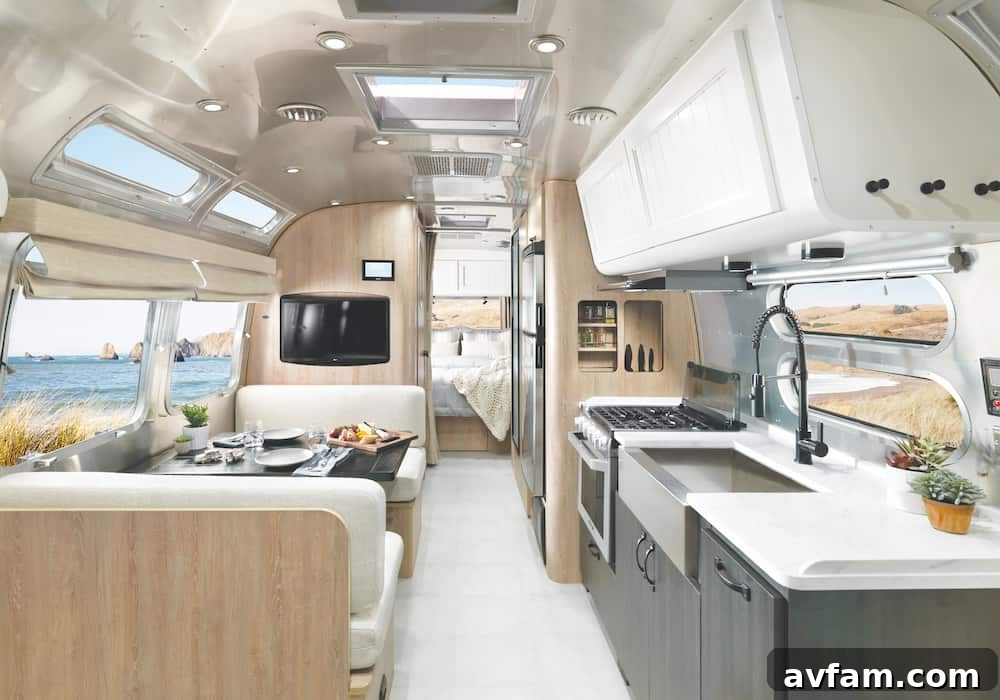 A welcoming interior view of the Airstream Pottery Barn Special Edition, showcasing the thoughtfully designed living and kitchen areas bathed in natural light.