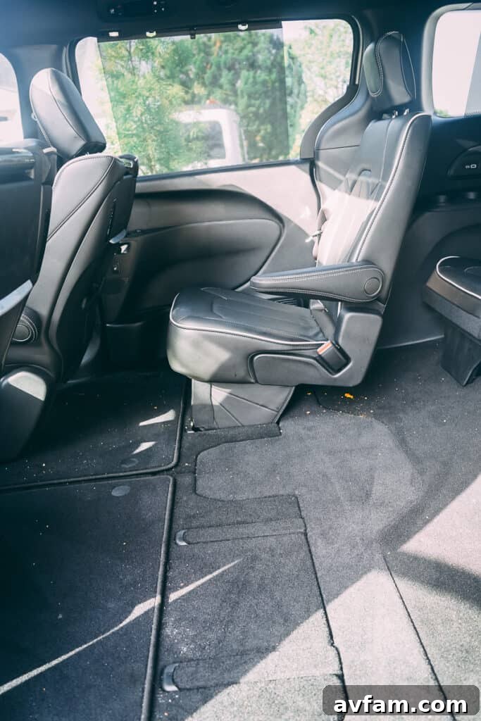 Chrysler Pacifica's signature Stow 'n Go seating in action, with a seat being folded into the floor.