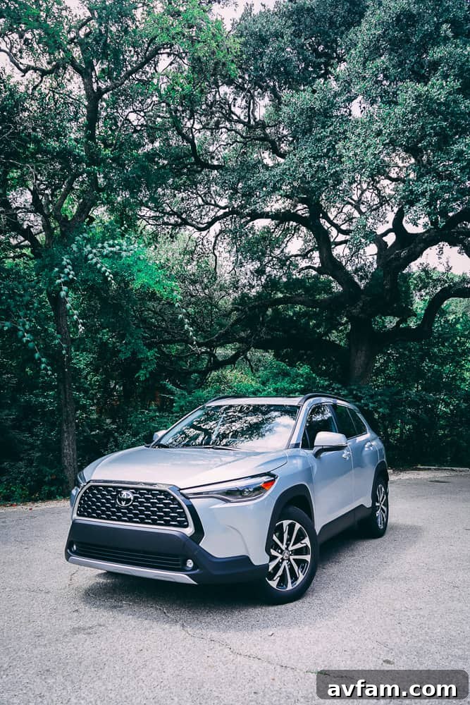 Front view of the 2022 Toyota Corolla Cross with its headlights illuminated.
