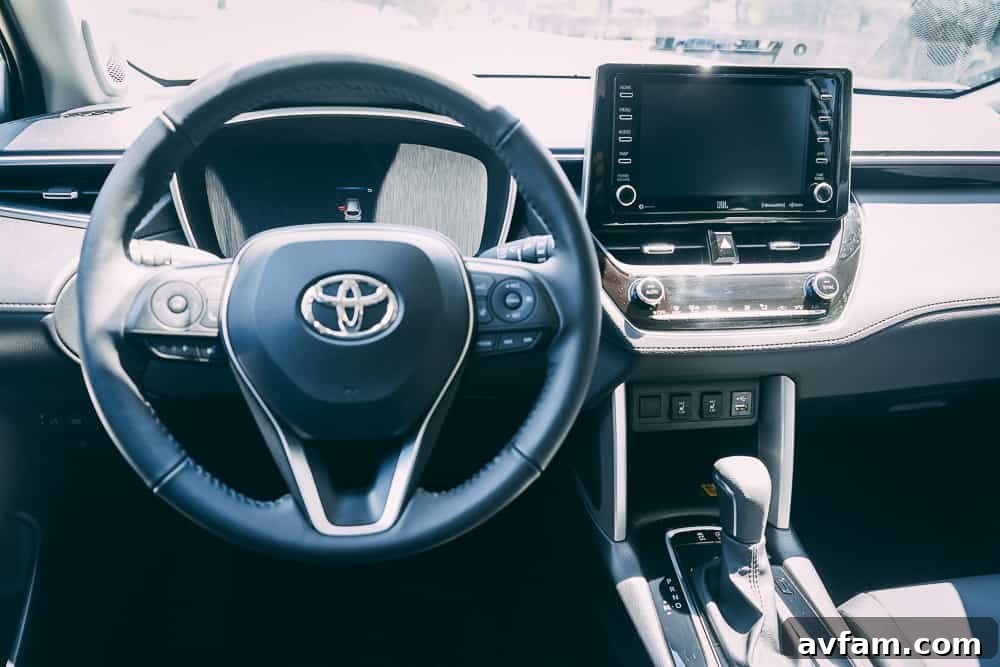 Front passenger seat view inside the 2022 Toyota Corolla Cross, highlighting legroom and dash design.