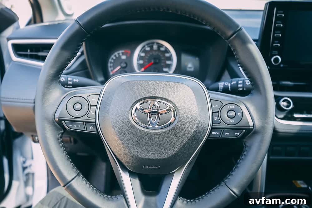 Front three-quarter view of the 2022 Toyota Corolla Cross in a bright outdoor setting.