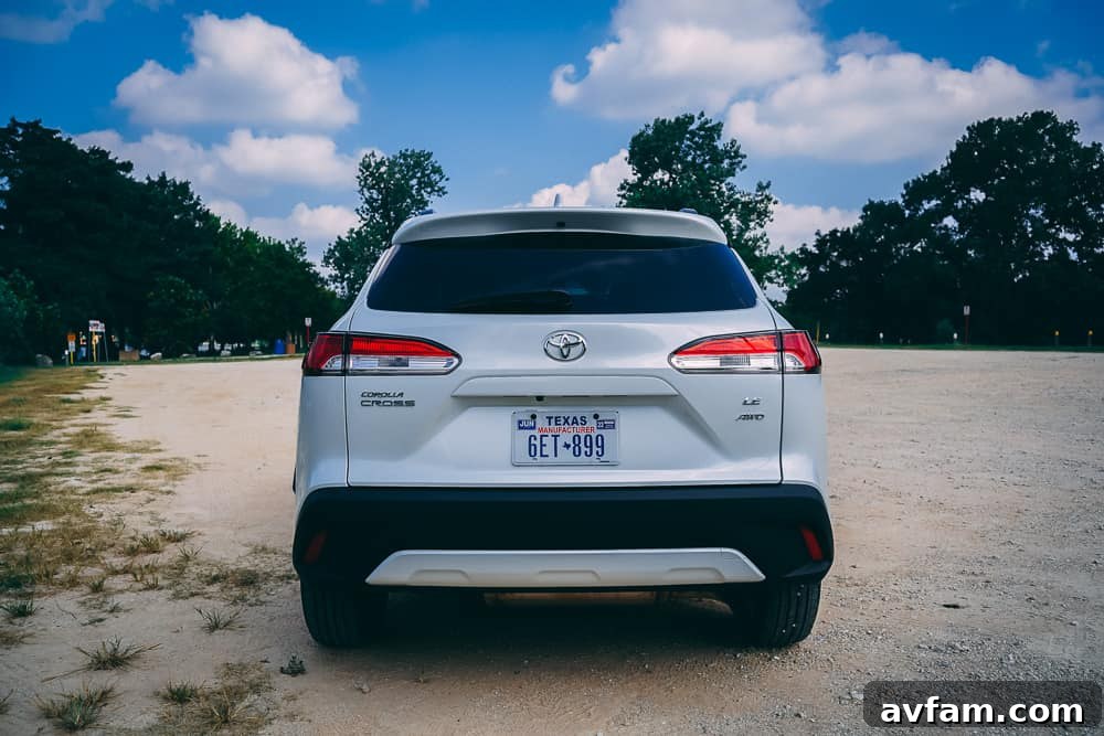 The 2022 Toyota Corolla Cross driving through a small town.
