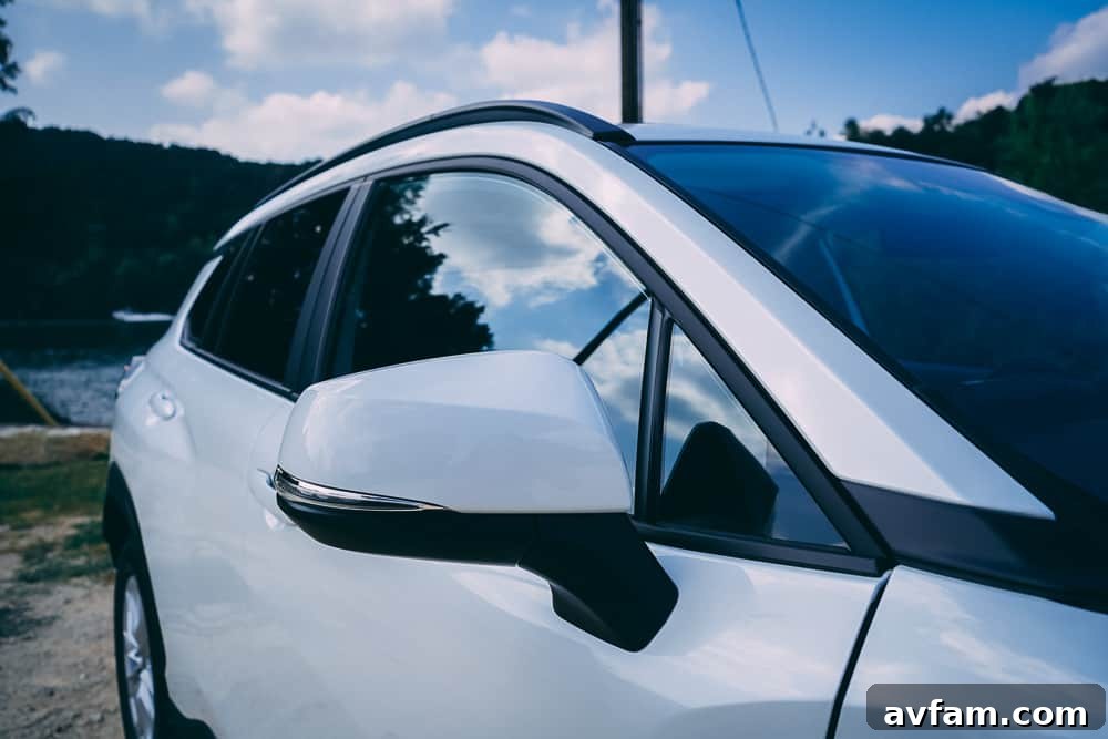 The 2022 Toyota Corolla Cross driving on a two-lane road with clear skies.