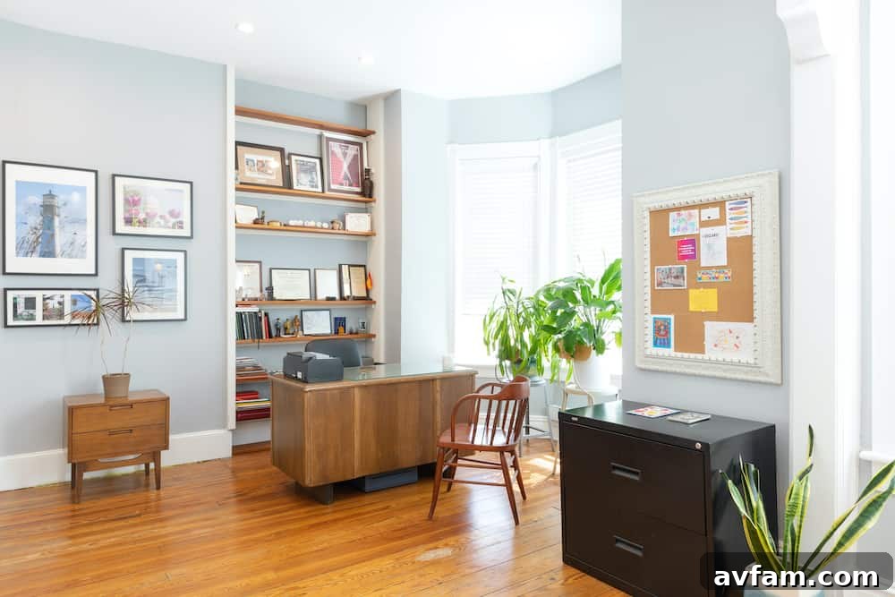 Richmond Restoration: A Historic House Reborn 15 After renovation: Modern home office with grey walls and built-in bookshelves in a historic Richmond VA house