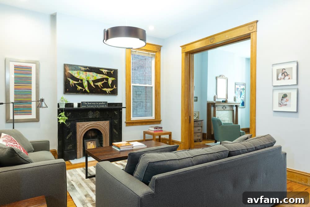 Richmond Restoration: A Historic House Reborn 21 After renovation: Bright living room with modern hanging lamp and recessed lights